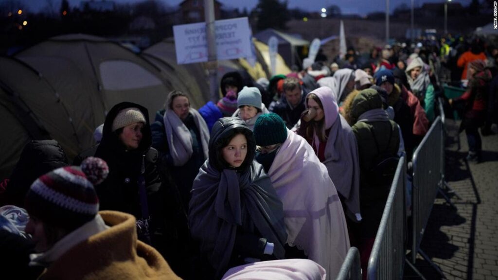 Refugees fleeing war in neighbouring Ukraine queue at the Medyka border crossing, Poland