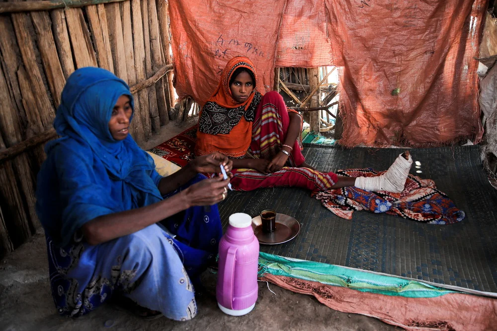 wo displaced Ethiopian women live in a tent after being forced to flee their homes in the Western Tigray region due to ethnic cleansing and crimes against humanity. 