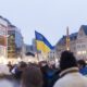 Protestors carrying Ukrainian flag.