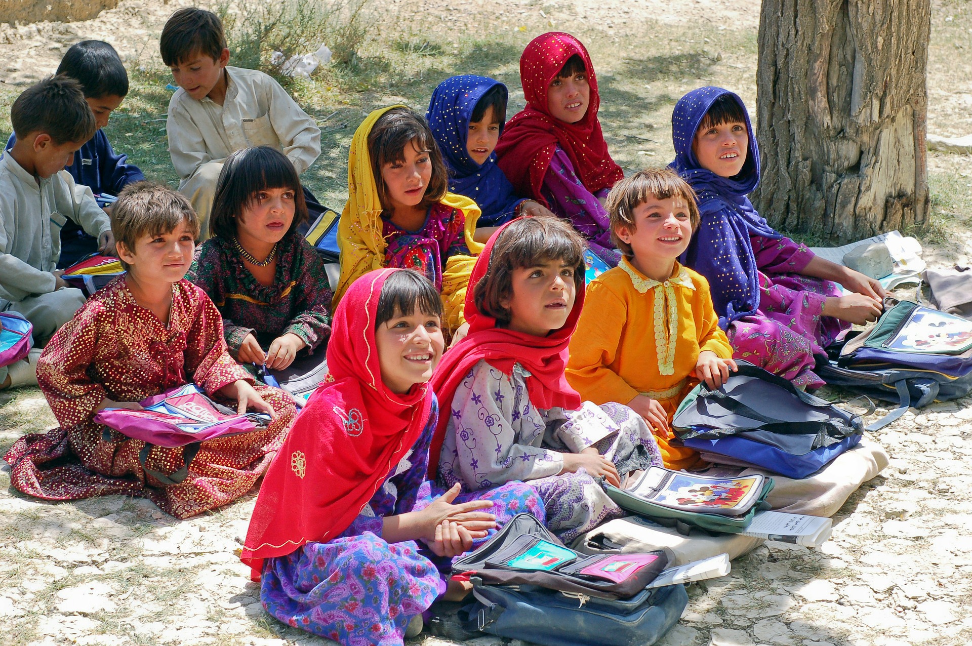 Afghani women sitting in line and holding books