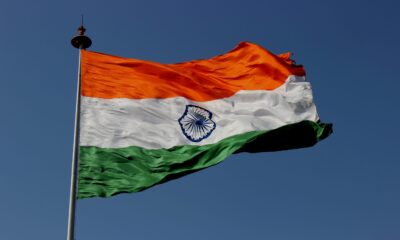 Indian flag swaying with blue sky in the background.