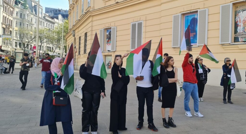 Participants holding Palestinian flags.