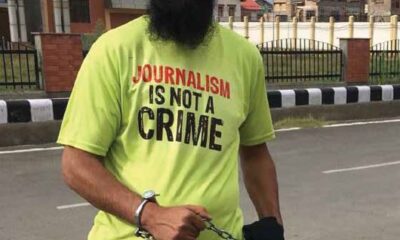Protestor wearing "Journalism is not a crime" shirt.