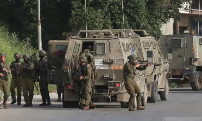 Israeli soldiers getting out of a military vehicle