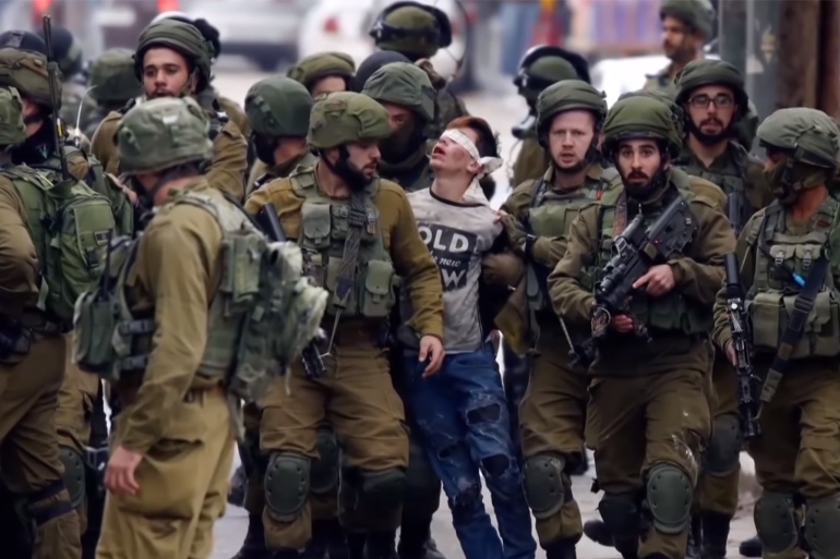Israeli defense forces arresting a child